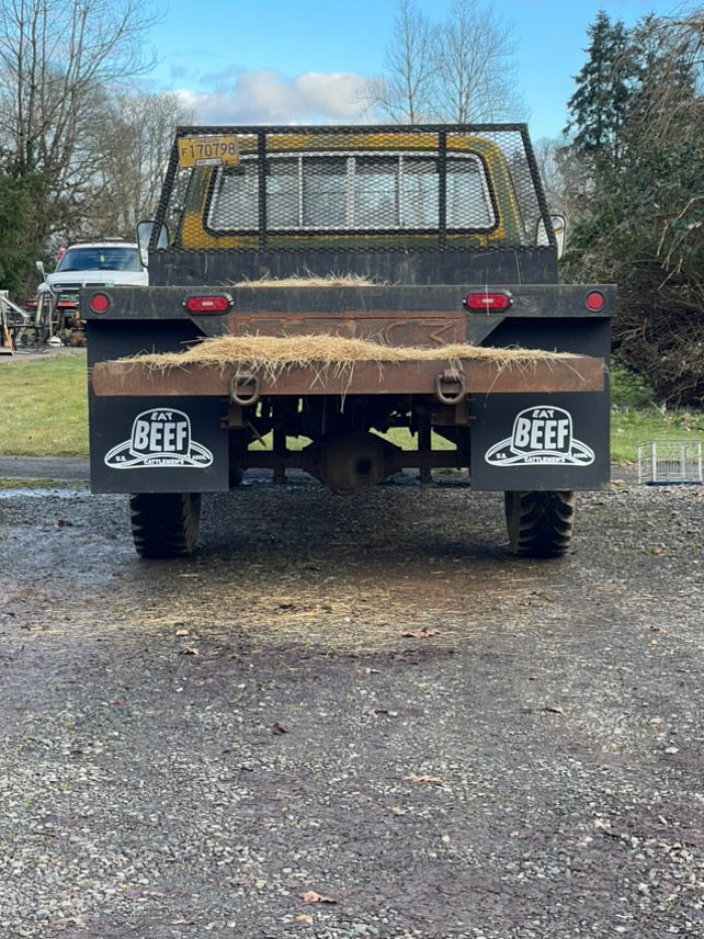 Straight on shot of Classic truck with Eat Beef 24x30 mudflaps installed