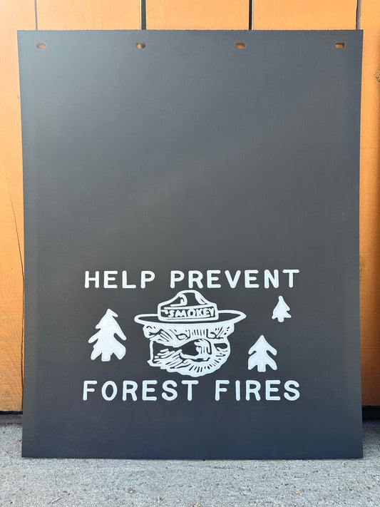 Mudflaps white text and graphics on a wooden background