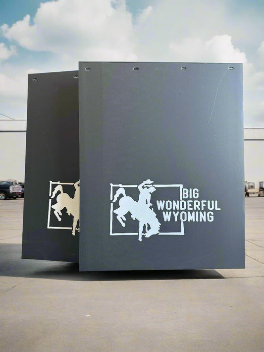 Mudflaps with cowboy graphics and 'Big Wonderful Wyoming' text 