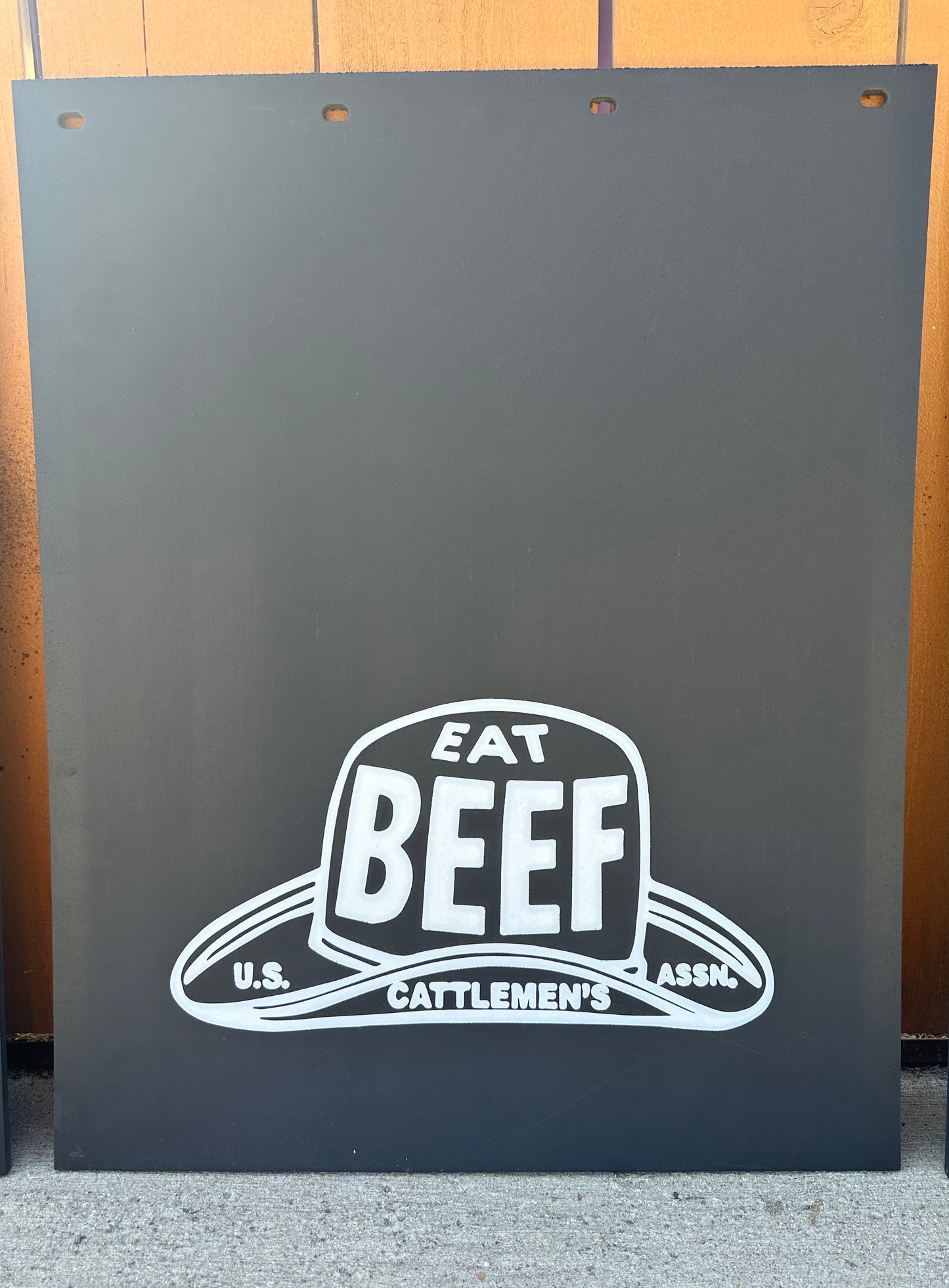 mudflaps with 'Eat Beef' logo on a wooden background