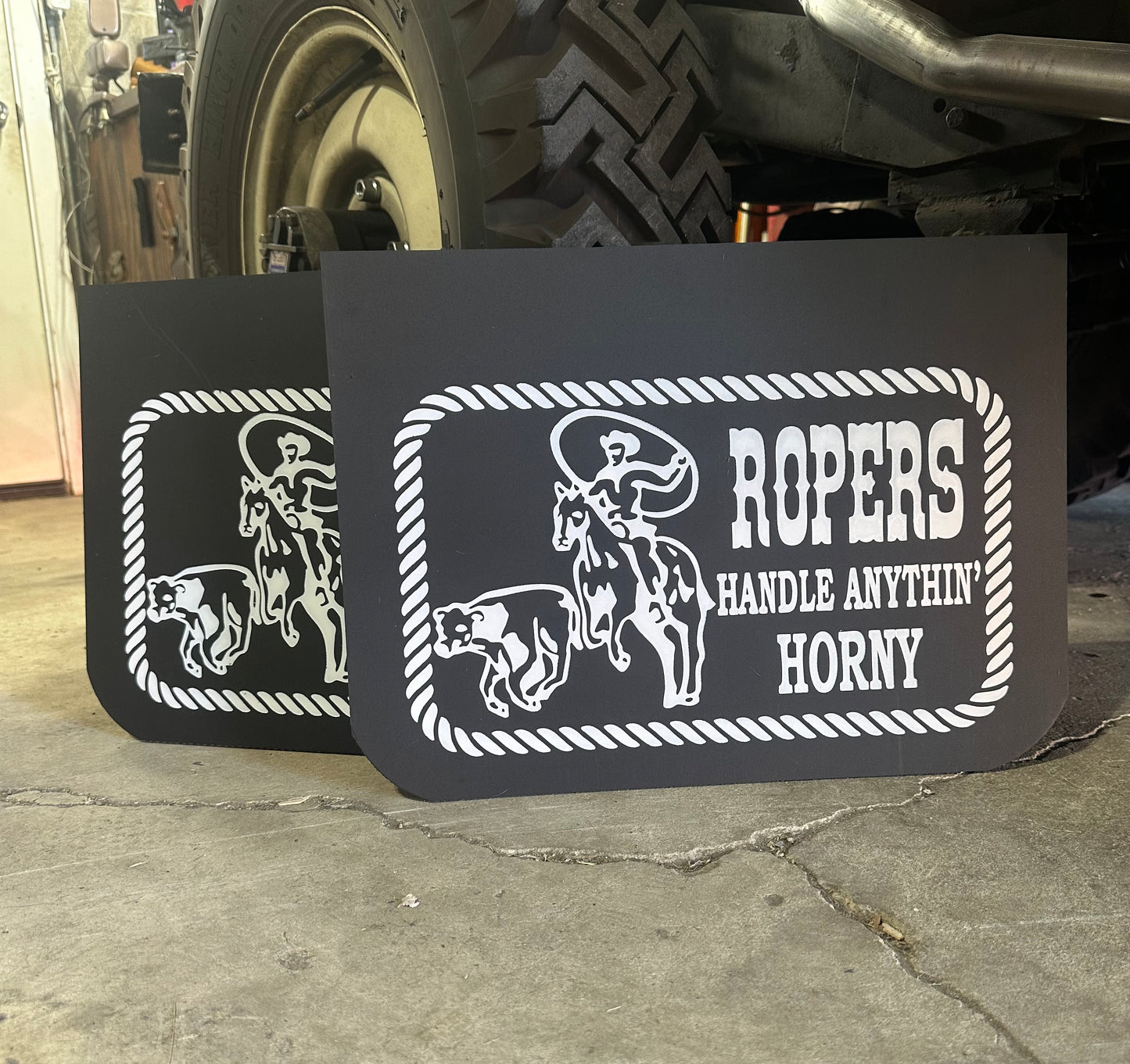 Mudflaps with vintage style text in a garage