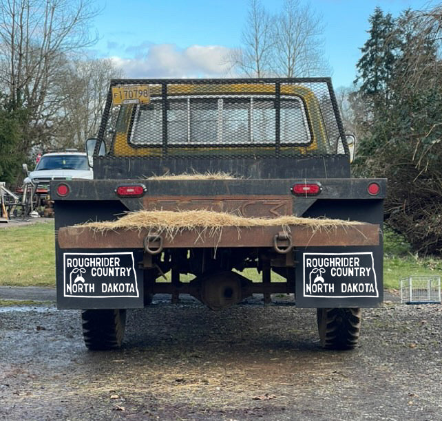 Wide shot of pickup truck with retro North Dakota Roughrider mudflaps