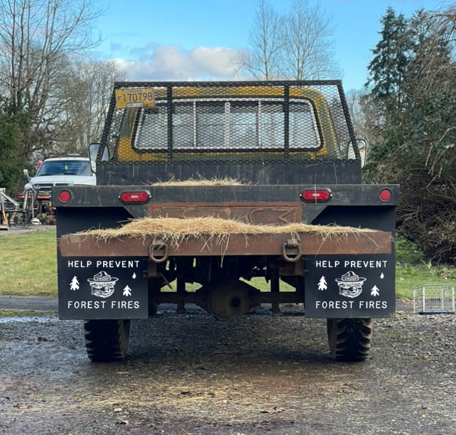 Wide shot of old school truck with Prevent Forest Fires mudflaps mounted